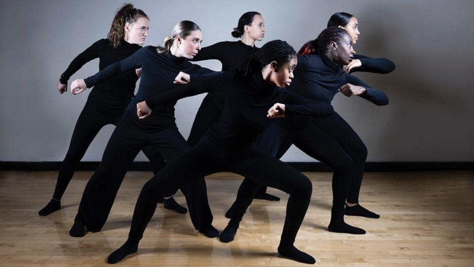 Six IRIE! performers wearing black