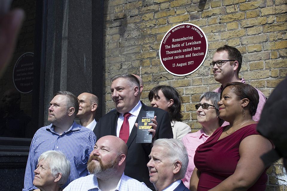 Members of Lewisham Council are photographed by the plaque
