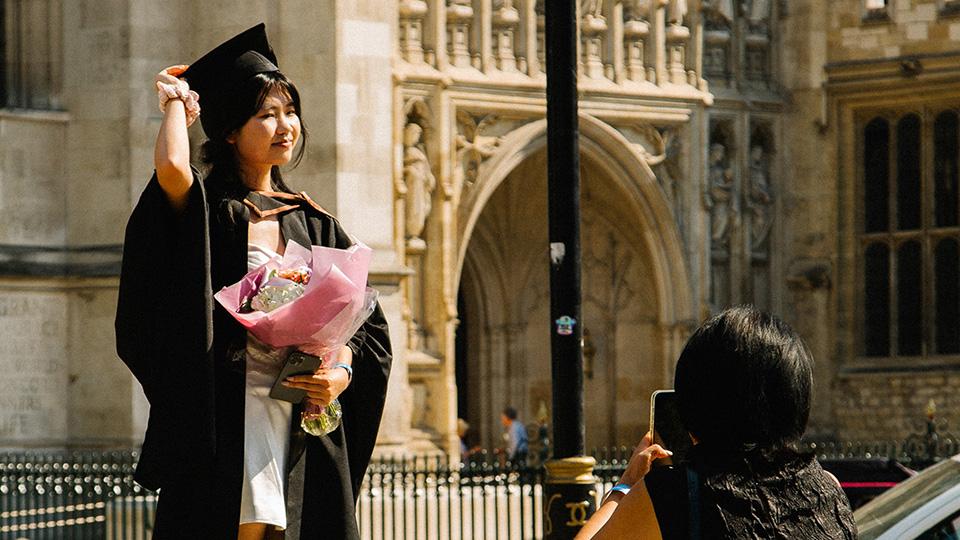 Students throwing their mortarboards in the air